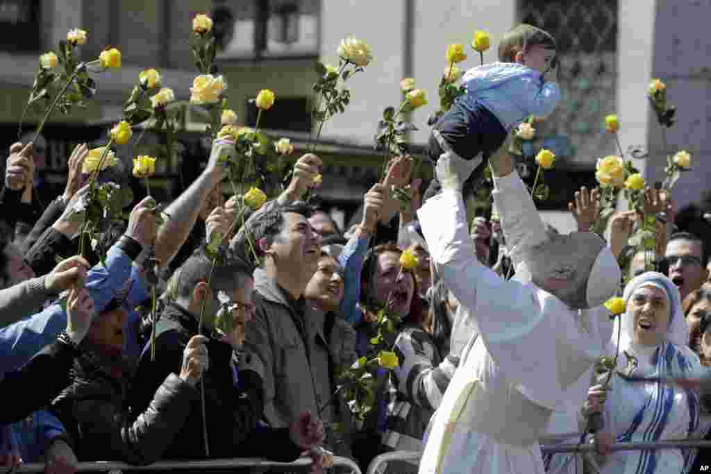 John Malkovich lifts a baby during the filming of &#39;The new Pope,&#39; the sequel of Paolo Sorrentino&#39;s &#39;The young Pope,&#39; in Rome, Italy, March 28, 2019.