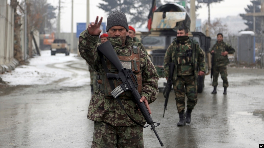 Afghan national army soldiers stand guard at the entrance gate of Marshal Fahim military academy in Kabul, Afghanistan, Monday, Jan. 29, 2018. Militants attacked an Afghan army unit guarding the military academy on Monday, officials said. Hours later, the Islamic State group claimed responsibility for the assault. (AP Photo/Rahmat Gul)
