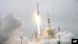 FILE - A rocket carrying the SpaceX Dragon ship lifts off from launch complex 40 at the Cape Canaveral Air Force Station in Cape Canaveral, Florida, April 18, 2014.