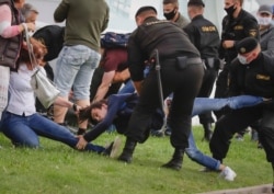 Police officers detain protesters during a rally against the removal of opposition candidates from the presidential elections in Minsk, Belarus, Tuesday, July 14, 2020.