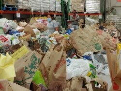 This warehouse overflows with food donations at Food For Others, a food bank in Fairfax, Virginia. (Deborah Block/VOA)