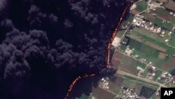 This Wednesday Feb. 15, 2012 satellite image shows a pipeline fire in Homs, Syria. The pipeline, which runs through the rebel-held neighborhood of Baba Amr, in Homs, had been shelled by regime troops for the previous 12 days, according to two activist gro
