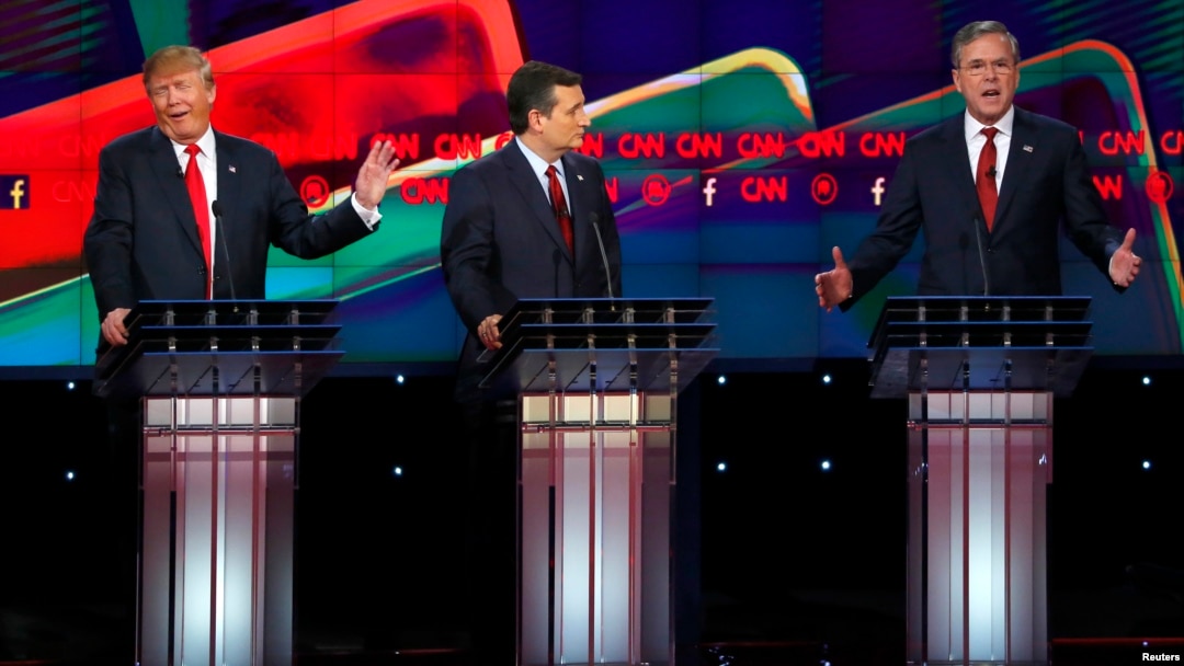Presidential candidate Donald Trump (L) responds to criticism from former Governor Jeb Bush (R) as Senator Ted Cruz (C) looks on during the Republican presidential debate in Las Vegas.