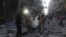 Syrian emergency personnel carry a body following an air strike on November 3, 2015, in the rebel-held side of the northern city of Aleppo.