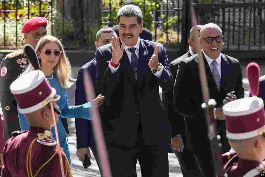 Venezuelan President Nicolas Maduro, center, and his wife Cilia Flores arrive at the National Assembly for Maduro&#39;s swearing-in ceremony for a third term in Caracas, Venezuela.