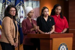 FILE - From left, Congresswomen Rashida Tlaib, Ilhan Omar, Alexandria Ocasio-Cortez, and Rep. Ayanna Pressley, respond to remarks by President Donald Trump during a news conference at the Capitol in Washington, July 15, 2019.