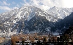 Snow covers areas of Kundalshahi, in Neelum Valley, Pakistan-administered Kashmir, Jan. 14, 2020.