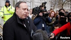 FILE - Democratic Unionist Party deputy leader Nigel Dodds speaks to reporters outside the Cabinet Office, in London, March 15, 2019.