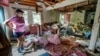 Cindy White looks over the devastation inside her home caused by Hurricane Helene in Morganton, North Carolina, Oct. 1, 2024. President Joe Biden will survey hurricane damage when he visits North Carolina on Wednesday.  