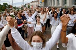 Women march in solidarity with protesters injured in the latest rallies against the results of the country's presidential election in Minsk, Belarus, Aug. 12, 2020.
