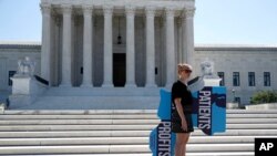An anti-abortion protester stands outside the U.S. Supreme Court in Washington, June 29, 2020. The court struck down a Louisiana law regulating abortion clinics.