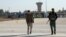 Members of the Kurdish-led Syrian Democratic Forces walk at Qamishli international airport in Qamishli, Syria, Dec. 9, 2024. 