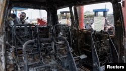 A person inspects the remains of a vehicle hit by heavy and light weapons during the fighting in the town that led to the fall of Goma into the hands of the M23 rebels, eastern Democratic Republic of Congo, Feb. 5, 2025. 