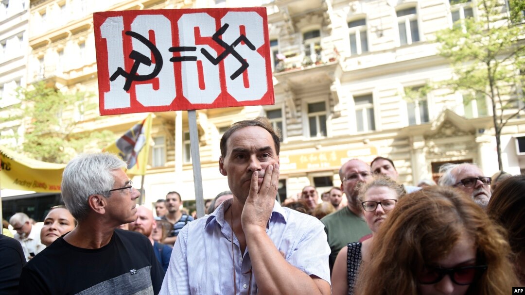 A protester holds a placard Aug. 21, 2018, in Prague, during commemorations marking the 50th anniversary of the Soviet invasion of former Czechoslovakia in 1968.