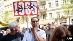 A protester holds a placard Aug. 21, 2018, in Prague, during commemorations marking the 50th anniversary of the Soviet invasion of former Czechoslovakia in 1968.