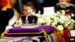 Hundreds of thousands of people are expected to flock to London’s medieval Westminster Hall from Wednesday, Sept. 14, 2022, to pay their respects to Queen Elizabeth II, whose coffin will lie in state for four days until her funeral on Monday. (AP Photo/Alastair Grant, File)