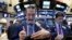 Trader Gregory Rowe, left, works on the floor of the New York Stock Exchange, Nov. 21, 2016. 