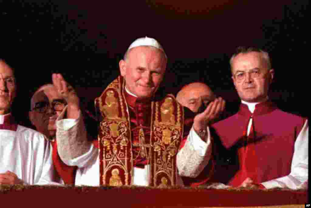 Pope John Paul II blesses the faithful in St. Peter's Square from a Vatican City balcony after he was named Pontiff in 1978 (AP)