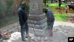 Workers begin removing a Confederate statue in Gainesville, Fla., Aug. 14, 2017. The statue is being returned to the local chapter of the United Daughters of the Confederacy, which erected the bronze statue in 1904.