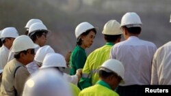 Burma pro-democracy leader Aung San Suu Kyi visits copper mine after meeting with villagers whose land was seized prior to extraction, Sarlingyi township, March 14, 2013.