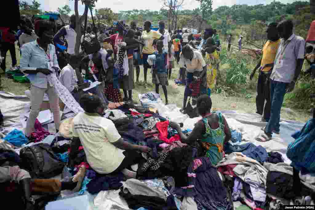At the refugee camp, refugees pick from donated clothings.