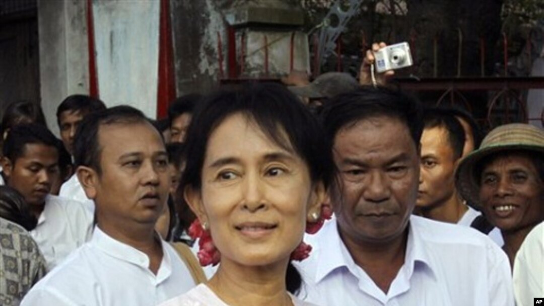 Pro-democracy leader Aung San Suu Kyi leaves her National League for Democracy party's headquarters on 22 Nov. 2010, in Rangoon.