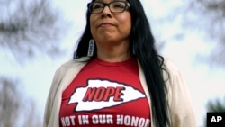 Rhonda LeValdo poses on Feb. 6, 2024, in Lawrence, Kansas. The Kansas City Chiefs, her hometown team and the focus of her protest, are playing in the Super Bowl this weekend. Levaldo is renewing her call for the team to change its name and ditch its logo.