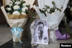 A makeshift memorial for Li Wenliang, a doctor who issued an early warning about the coronavirus outbreak before it was officially recognized, is seen after Li died of the virus, at Central Hospital of Wuhan in Hubei province, China Feb. 7, 2020.