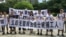 People hold banners at a demonstration in support of factory workers of Jasic Technology, outside Yanziling police station in Pingshan district, Shenzhen, Guangdong province, China, Aug. 6, 2018.