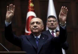Turkish President Recep Tayyip Erdogan gestures as he addresses his ruling party legislators at the Parliament, in Ankara, Wednesday, Oct 16, 2019. Erdogan called Wednesday on Syrian Kurdish fighters to leave a designated border area in northeast…