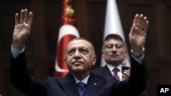 Turkish President Recep Tayyip Erdogan gestures as he addresses his ruling party legislators at the Parliament in Ankara, Oct 16, 2019. 