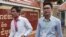 FILE - Journalists Uon Chhin, left, and Yeang Sothearin arrive at the municipal court in Phnom Penh, Cambodia, Aug. 30, 2019. 