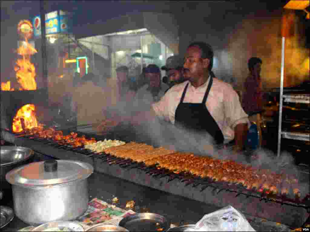 ایک ریسٹورنٹ کے باہر باربی کیو تیار کیاجارہاہے