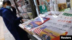 A picture of Chinese President Xi Jinping attending a virtual meeting with US President Joe Biden via video link is seen on a newspaper front page, at a newsstand in Beijing, China, Nov. 17, 2021. 