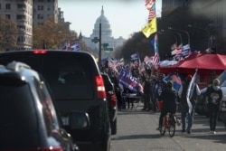 Supporters of President Donald Trump cheer alongside his presidential motorcade at Freedom Plaza near the White House in Washington, Nov. 14, 2020.