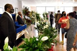 People pay their respects during a memorial service for George Floyd, June 6, 2020, in Raeford, N.C. Floyd died after being restrained by Minneapolis police officers on May 25.