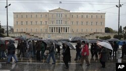 Pensioners march during an anti-austerity rally in front of the parliament in Athens, Greece, February 22, 2012.