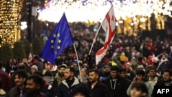 Anti-government demonstrators protest against the Georgian government's postponement of European Union accession talks until 2028, outside the parliament in central Tbilisi on Dec. 31, 2024