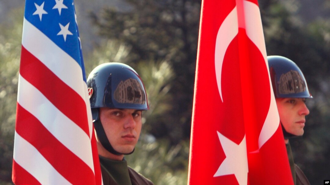 Turkish guards of honor stand with U.S. and Turkish flags before the arrival of U.S. Defense Secretary Robert Gates and Turkish Defense Minister Vecdi Gonul for a ceremony in Ankara, Turkey, Saturday, Feb. 6, 2010. (AP Photo/Burhan Ozbilici)