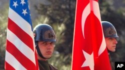 Turkish guards of honor stand with U.S. and Turkish flags before the arrival of U.S. Defense Secretary Robert Gates and Turkish Defense Minister Vecdi Gonul for a ceremony in Ankara, Turkey, Saturday, Feb. 6, 2010. (AP Photo/Burhan Ozbilici)