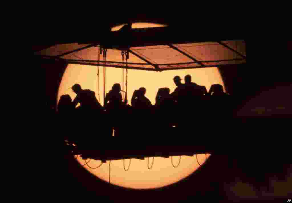 People have dinner on a platform raised by a crane to a height of 50 meters as they participate the traveling international project &#39;Dinner in the Sky&#39; in St. Petersburg, Russia, June 2, 2021.