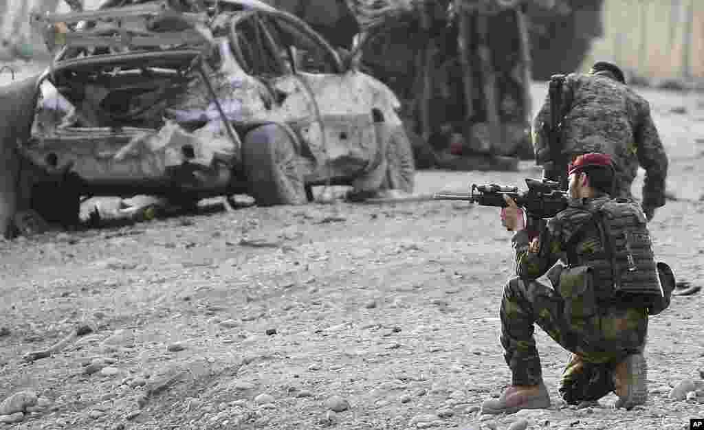 An Afghan soldier at the scene of a suicide attack at the gate of an airport in Jalalabad, Nangarhar province on February 27, 2012. (AP)