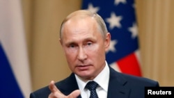 Russian President Vladimir Putin gestures during a joint news conference with U.S. President Donald Trump (not pictured) after their meeting in Helsinki, Finland July 16, 2018.