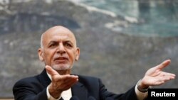 FILE - Afghan President Ashraf Ghani speaks during a news conference in Kabul, Afghanistan, July 15, 2018. He telephoned neighboring Pakistan’s would-be prime minister, Imran Khan, to congratulate him on his election victory and invited him to visit Kabul. 