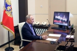 Russian President Vladimir Putin chairs a meeting with Russian regional officials via videoconference at the Novo-Ogaryovo residence outside Moscow, March 30, 2020.