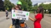 A reporter interviews logger Bridger Hasbrouck, of Dallas, Ore., in Salem, Ore., June 20, 2019, the day the Senate was to take up a bill creating a cap-and-trade program to curb carbon emissions. Senate Republicans, however, walked out, preventing a vote on House Bill 2020.
