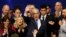 Israeli Prime Minister Benjamin Netanyahu stands next to his wife, Sara, as he waves to supporters following the announcement of exit polls in Israel's election at his Likud party headquarters in Tel Aviv, Israel, March 3, 2020.
