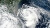 Gambar satelit yang dirilis oleh NASA menunjukkan Topan Hagupit mendekati Taiwan, tengah kiri, Minggu, 2 Agustus 2020. 