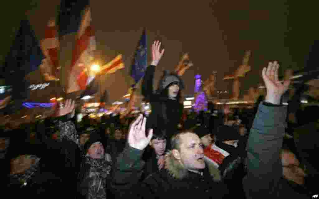 Opposition supporters shout slogans during a rally in Minsk, Belarus, early Monday, Dec. 20, 2010. Thousands of opposition supporters in Belarus tried to storm the main government building to protest what the opposition claims was large-scale vote-rigging