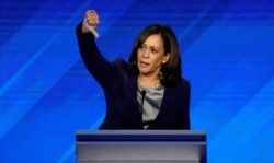 FILE - Senator Kamala Harris gives a thumbs down as she speaks during the 2020 Democratic U.S. presidential debate in Houston, Sept. 12, 2019.